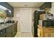 Functional kitchen with dark cabinets, stainless steel sink, and appliances, ready for culinary adventures at 809 Longbranch Ln, Douglasville, GA 30134