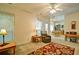 Inviting living room features a ceiling fan and a cozy chair, seamlessly flowing into the adjacent dining area at 809 Longbranch Ln, Douglasville, GA 30134