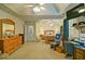 Spacious main bedroom featuring a ceiling fan, desk, wooden dresser, and comfortable seating at 809 Longbranch Ln, Douglasville, GA 30134