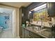 Finished basement wet bar with stainless steel sink and modern black cabinets at 809 Longbranch Ln, Douglasville, GA 30134