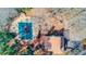 Aerial view of a backyard pool with a slide and lounge area, enveloped by a canopy of mature trees at 1144 Country Ct, Lawrenceville, GA 30044