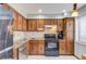 Traditional kitchen featuring wood cabinets, granite countertops and stainless steel appliances at 1144 Country Ct, Lawrenceville, GA 30044