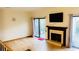 Bright living room with a fireplace, hardwood floors, and sliding door access to the outside at 1144 Country Ct, Lawrenceville, GA 30044