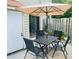 Outdoor patio space with table, chairs, and umbrella at 1144 Country Ct, Lawrenceville, GA 30044