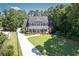 Beautiful home with a long, winding driveway, set among lush greenery and mature trees at 395 Grove Ridge Dr, Loganville, GA 30052