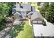 Aerial view showcasing the expansive backyard, deck, two-car garage, and mature landscaping of the property at 395 Grove Ridge Dr, Loganville, GA 30052