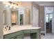Bathroom vanity featuring white countertops, green cabinetry, and modern fixtures at 395 Grove Ridge Dr, Loganville, GA 30052
