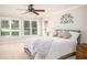 Bright bedroom with plush carpet, neutral paint and large windows overlooking the yard at 395 Grove Ridge Dr, Loganville, GA 30052