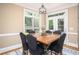 Inviting dining area featuring a wooden table, comfortable seating, and natural light from large windows at 395 Grove Ridge Dr, Loganville, GA 30052