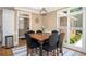 Cozy dining area with a large wooden table, comfortable seating, and ample natural light at 395 Grove Ridge Dr, Loganville, GA 30052