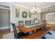 Bright dining room with a long wooden table, bench seating, and stylish decor at 395 Grove Ridge Dr, Loganville, GA 30052