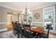 Inviting dining room with wood table, chairs, chandelier, and natural light at 395 Grove Ridge Dr, Loganville, GA 30052