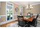 Dining room featuring a chandelier, wainscoting, and access to the living area at 395 Grove Ridge Dr, Loganville, GA 30052