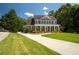 Inviting two-story home with a spacious front yard, long driveway, and classic architectural design at 395 Grove Ridge Dr, Loganville, GA 30052