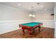 Spacious game room features a classic billiard table and hardwood flooring at 395 Grove Ridge Dr, Loganville, GA 30052