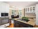 A modern kitchen showcasing granite countertops, stainless steel appliances, and an adjacent dining area at 395 Grove Ridge Dr, Loganville, GA 30052