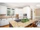 Bright kitchen features granite countertops, stainless steel appliances, and a central island with a cooktop at 395 Grove Ridge Dr, Loganville, GA 30052