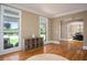 Bright living room with wood floors, shelving unit and natural light at 395 Grove Ridge Dr, Loganville, GA 30052