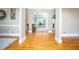 Bright living room with hardwood floors, large windows, and a view to the adjoining room at 395 Grove Ridge Dr, Loganville, GA 30052