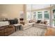 Open living room with large windows, comfortable sofa and decorative rug at 395 Grove Ridge Dr, Loganville, GA 30052