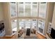 Bright, open living room featuring a corner couch, hardwood floors, and lots of natural light at 395 Grove Ridge Dr, Loganville, GA 30052