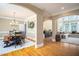 Open-concept living space with hardwood floors, views of the dining room, and a cozy Gathering room at 395 Grove Ridge Dr, Loganville, GA 30052