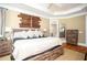 Spacious main bedroom with tray ceiling, and a rustic design aesthetic with wood accents at 395 Grove Ridge Dr, Loganville, GA 30052
