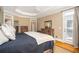 Spacious main bedroom featuring a tray ceiling, hardwood floors and dark wood furniture at 395 Grove Ridge Dr, Loganville, GA 30052