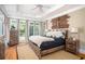 Serene bedroom with hardwood floors, natural lighting from multiple windows, and rustic wood furnishings at 395 Grove Ridge Dr, Loganville, GA 30052