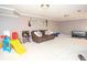Spacious playroom offers a comfortable couch and assorted toys at 395 Grove Ridge Dr, Loganville, GA 30052