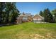 Expansive home with a large manicured lawn and a three-car garage at 395 Grove Ridge Dr, Loganville, GA 30052