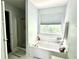 Bright bathroom features a soaking tub with a window and a separate shower at 627 Arbour Way, Suwanee, GA 30024