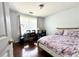Well-lit bedroom with modern desk, dark wood floors and neutral walls at 627 Arbour Way, Suwanee, GA 30024