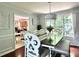Bright dining room features a large table and view to the kitchen at 627 Arbour Way, Suwanee, GA 30024