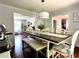 Dining room with view to Living Room featuring table with bench and chairs at 627 Arbour Way, Suwanee, GA 30024