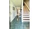 Inviting foyer with tile flooring, staircase, and view of dining area at 627 Arbour Way, Suwanee, GA 30024