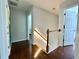Light-filled hallway with wood floors and railing at 627 Arbour Way, Suwanee, GA 30024