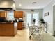 Eat-in kitchen with light-colored floors, wooden cabinets and door to backyard at 627 Arbour Way, Suwanee, GA 30024