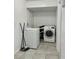 Functional laundry room with modern washer and dryer units at 627 Arbour Way, Suwanee, GA 30024