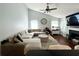 Spacious living room featuring a plush sectional sofa, fireplace, and a vaulted ceiling at 627 Arbour Way, Suwanee, GA 30024