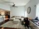Bright living room with hardwood floors, a ceiling fan, and open floor plan at 627 Arbour Way, Suwanee, GA 30024