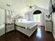 Well-lit main bedroom with hardwood floors, a ceiling fan, and a large window at 627 Arbour Way, Suwanee, GA 30024