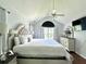 Well-lit main bedroom with hardwood floors, a ceiling fan, and a large window at 627 Arbour Way, Suwanee, GA 30024