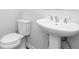 Clean bathroom featuring a classic white toilet and a pedestal sink at 1517 Ellie Ridge Ave, Lawrenceville, GA 30043