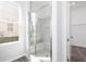 Bathroom featuring a glass shower with stone tile design at 1517 Ellie Ridge Ave, Lawrenceville, GA 30043