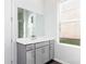 Bathroom featuring a grey vanity and a large mirror above it at 1517 Ellie Ridge Ave, Lawrenceville, GA 30043