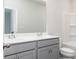 Bathroom featuring a double vanity, modern fixtures, and a shower-tub combo at 1517 Ellie Ridge Ave, Lawrenceville, GA 30043