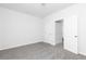 A carpeted bedroom featuring a door leading to another room, providing a sense of flow at 1517 Ellie Ridge Ave, Lawrenceville, GA 30043