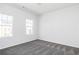 Bedroom with gray carpet and two large windows at 1517 Ellie Ridge Ave, Lawrenceville, GA 30043