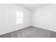 A carpeted bedroom with a window allowing natural light to fill the space at 1517 Ellie Ridge Ave, Lawrenceville, GA 30043